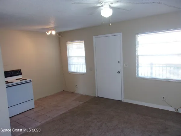 a view of a kitchen with a dishwasher cabinets and a window