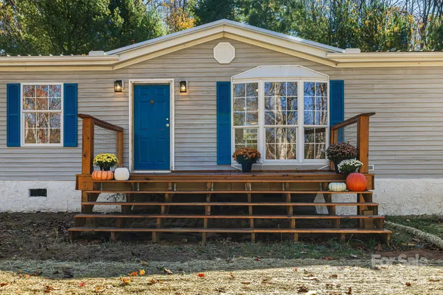 a front view of a house with plants