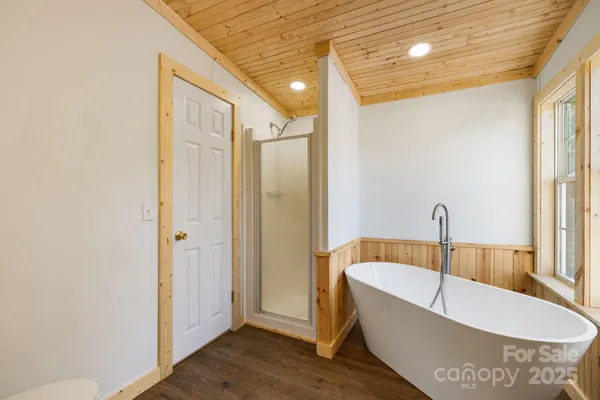 a bathroom with a tub and shower