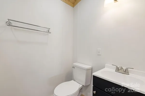 a white toilet sitting next to a bathroom sink