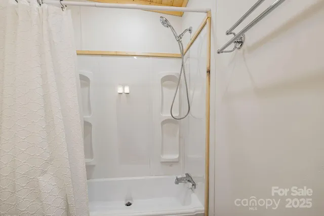 a bathroom with a shower and a shower
