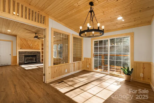 a view of empty room with wooden floor and fireplace