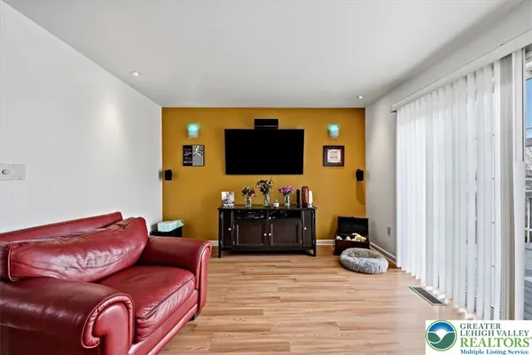 a kitchen with stainless steel appliances granite countertop a stove top oven a sink a dining table and chairs
