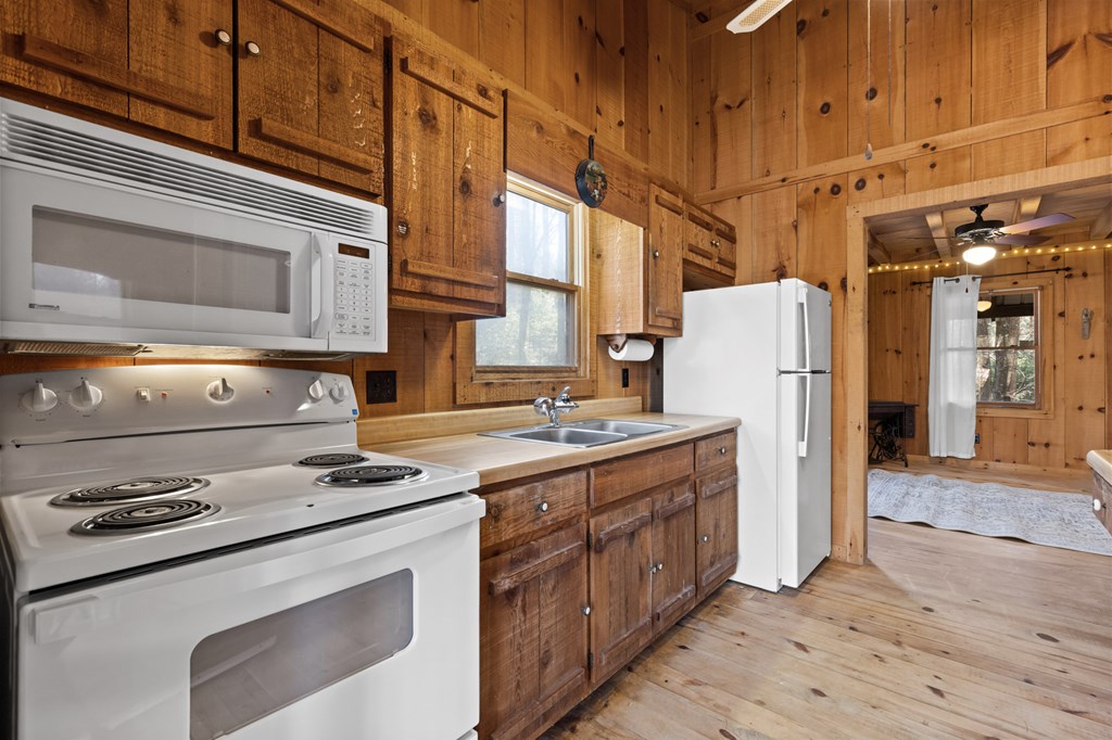 104 Big Tree Road Suches, GA 30572 - Photo 12 of 19 a kitchen with a stove a refrigerator and cabinets