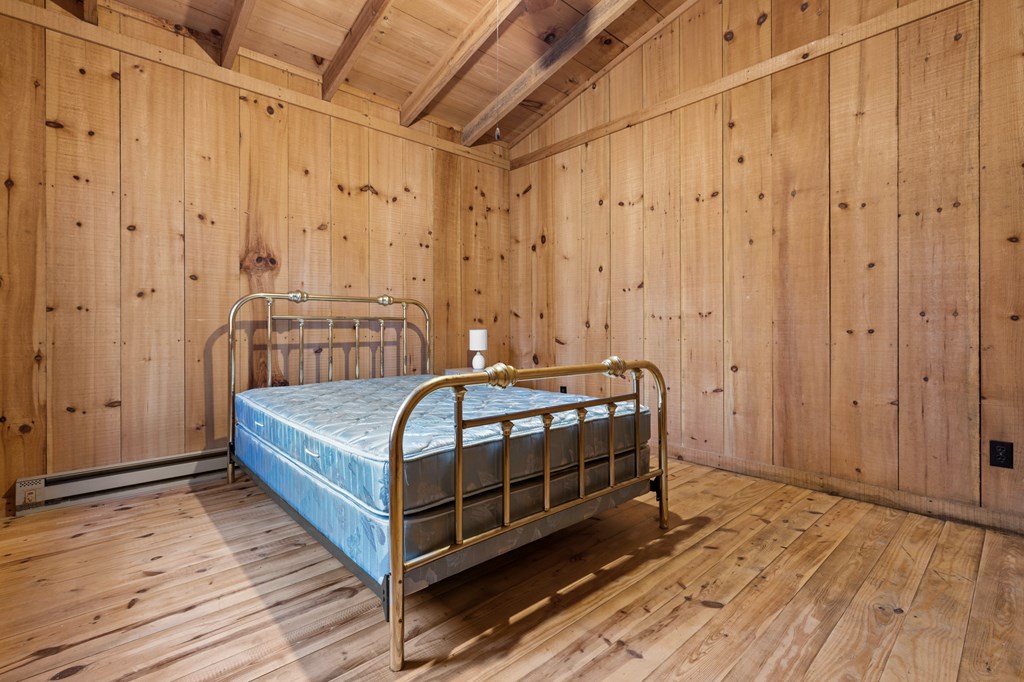 104 Big Tree Road Suches, GA 30572 - Photo 13 of 19 a bedroom with a bed and a wooden door
