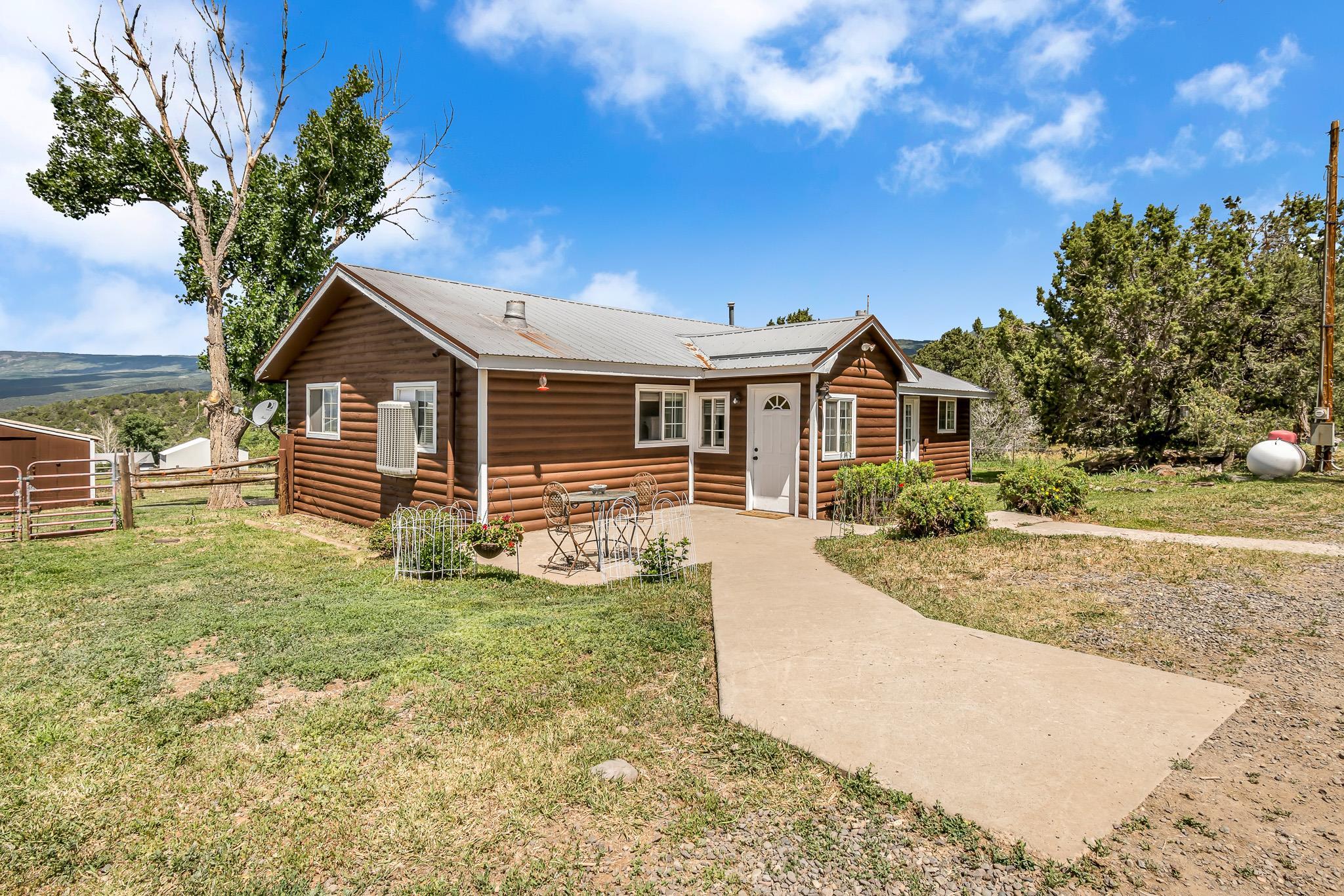 24413 Ute Trail Road Cedaredge, CO 81413 - Photo 1 of 40 a front view of a house with a yard
