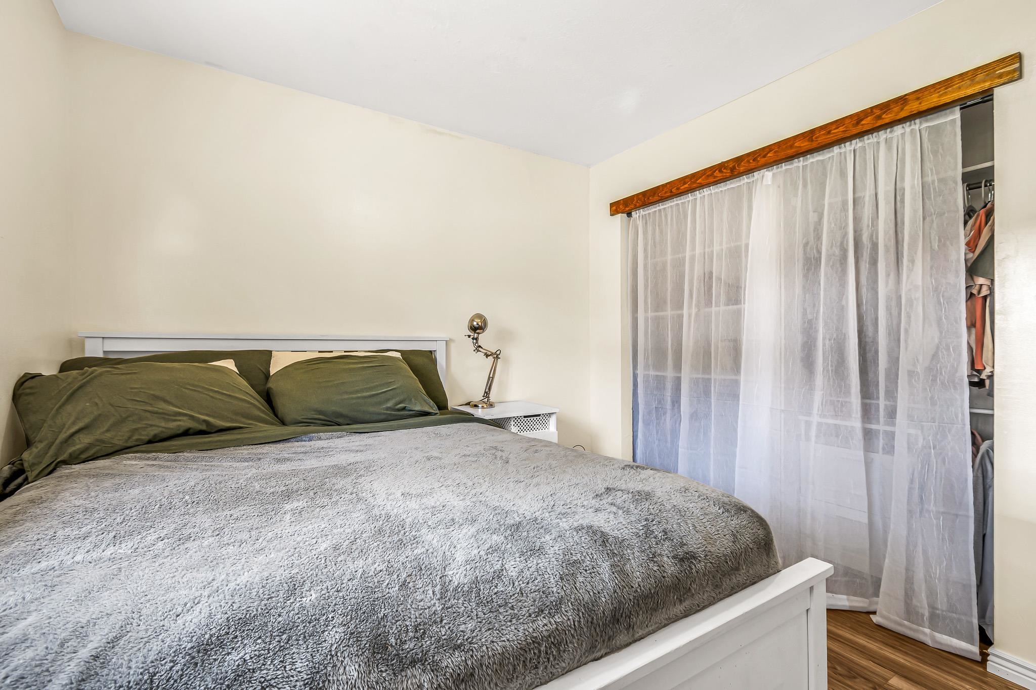 24413 Ute Trail Road Cedaredge, CO 81413 - Photo 14 of 40 a bed sitting in a bedroom and wooden floor