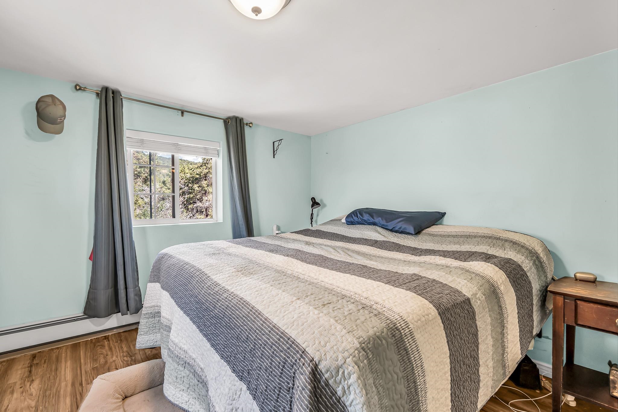 24413 Ute Trail Road Cedaredge, CO 81413 - Photo 15 of 40 a bedroom with a bed and a window