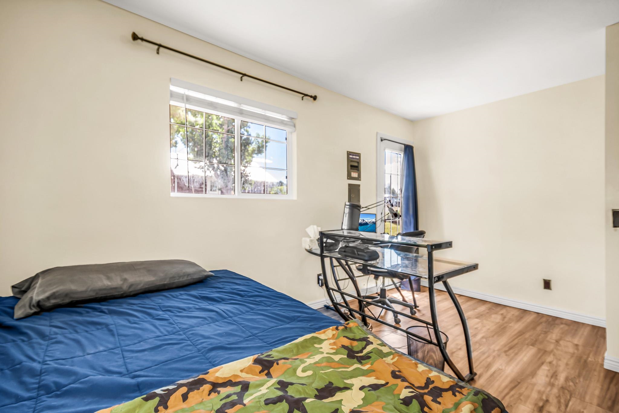 24413 Ute Trail Road Cedaredge, CO 81413 - Photo 19 of 40 a bedroom with a bed and a table in it