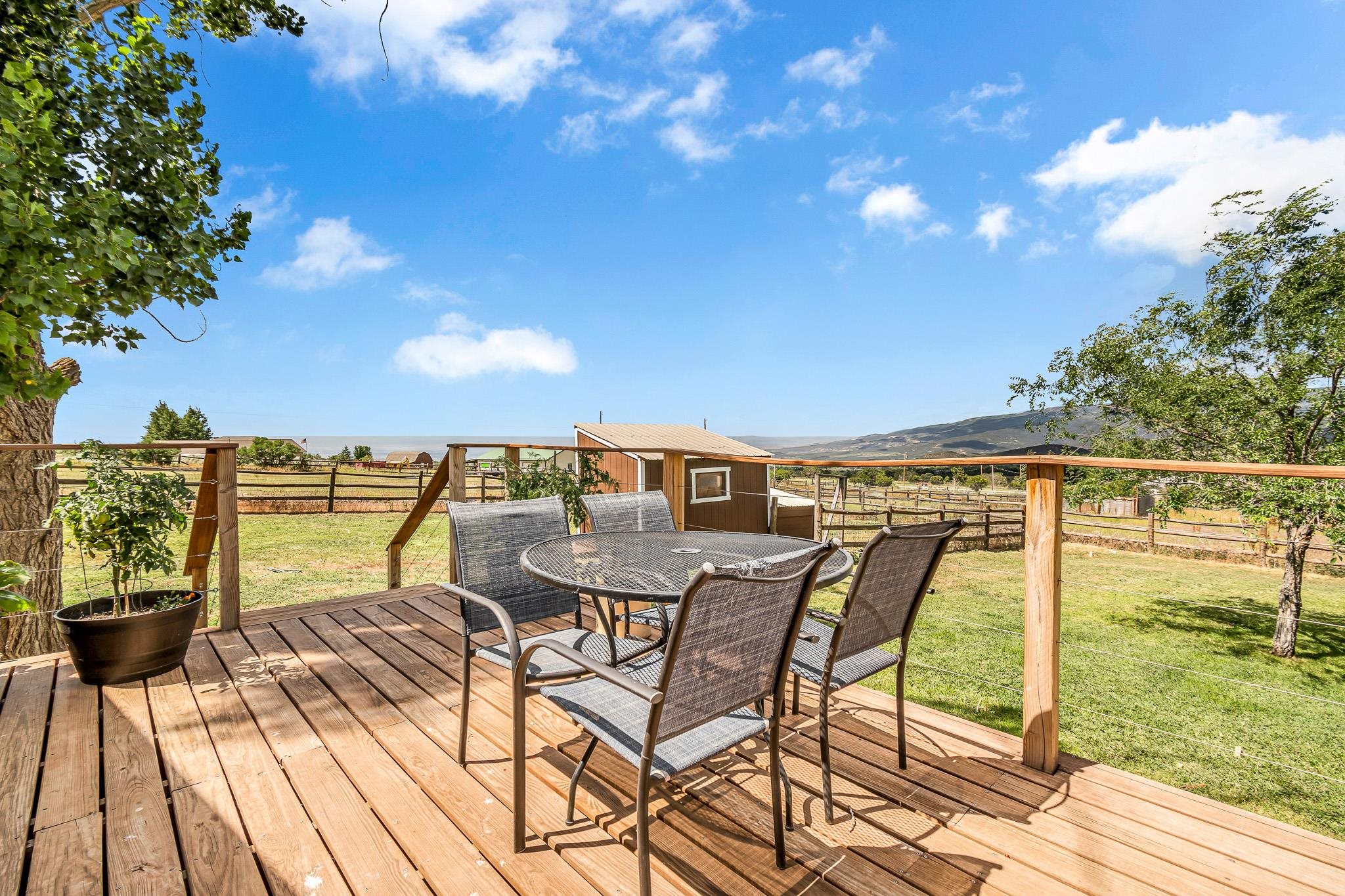 24413 Ute Trail Road Cedaredge, CO 81413 - Photo 22 of 40 a view of a chairs and table on the terrace