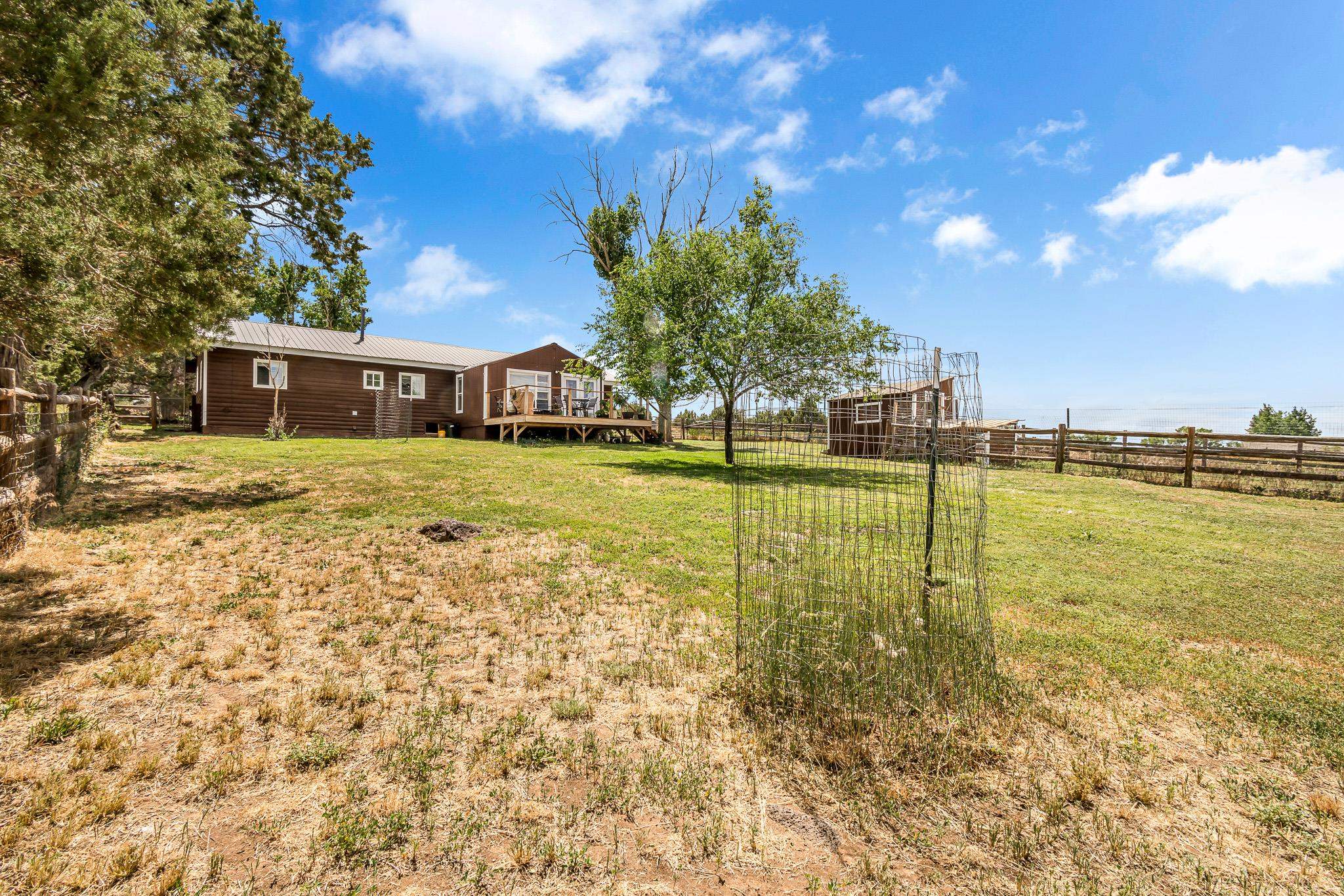 24413 Ute Trail Road Cedaredge, CO 81413 - Photo 26 of 40 a swimming pool with outdoor seating and yard