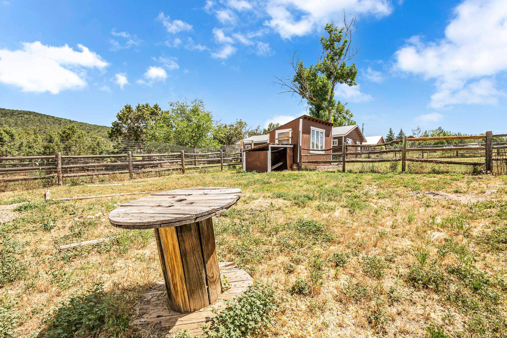 24413 Ute Trail Road Cedaredge, CO 81413 - Photo 29 of 40 a view of a balcony with a table and chairs
