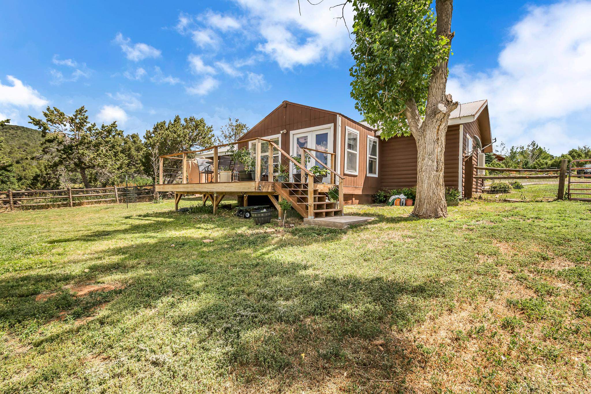 24413 Ute Trail Road Cedaredge, CO 81413 - Photo 31 of 40 a backyard of a house with lots of green space