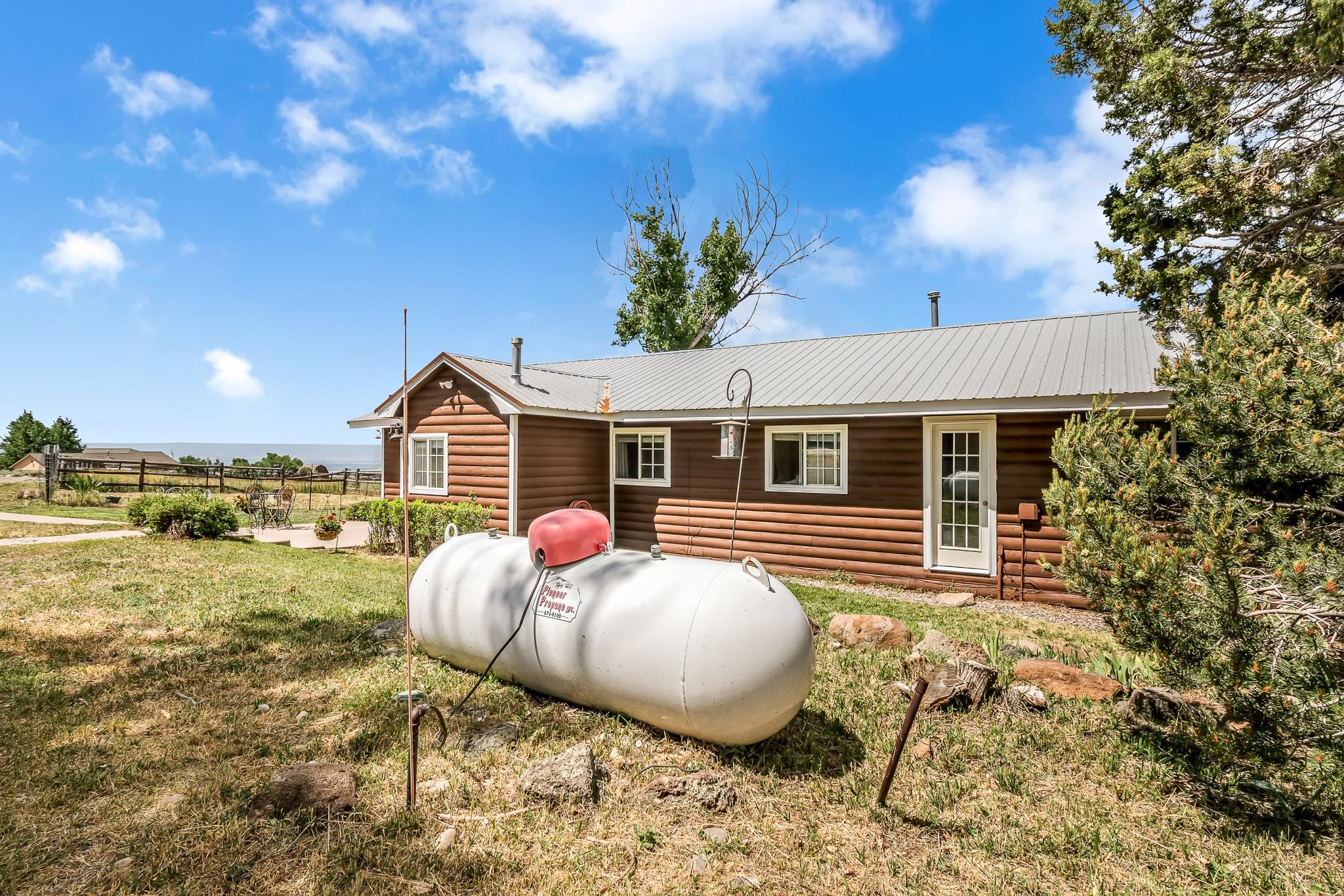24413 Ute Trail Road Cedaredge, CO 81413 - Photo 32 of 40 a view of a house with backyard and sitting area