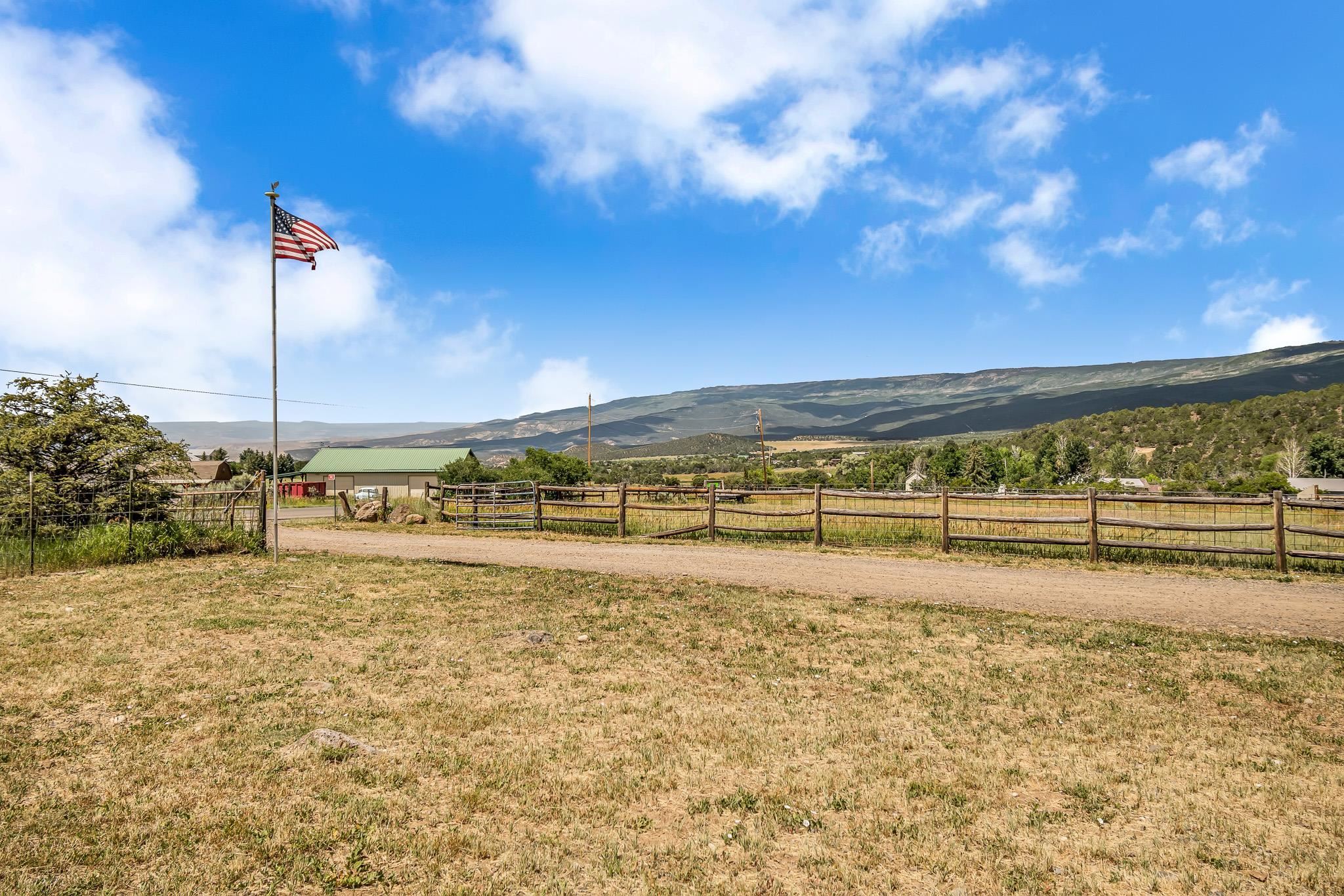 24413 Ute Trail Road Cedaredge, CO 81413 - Photo 38 of 40 a view of a yard with an ocean view
