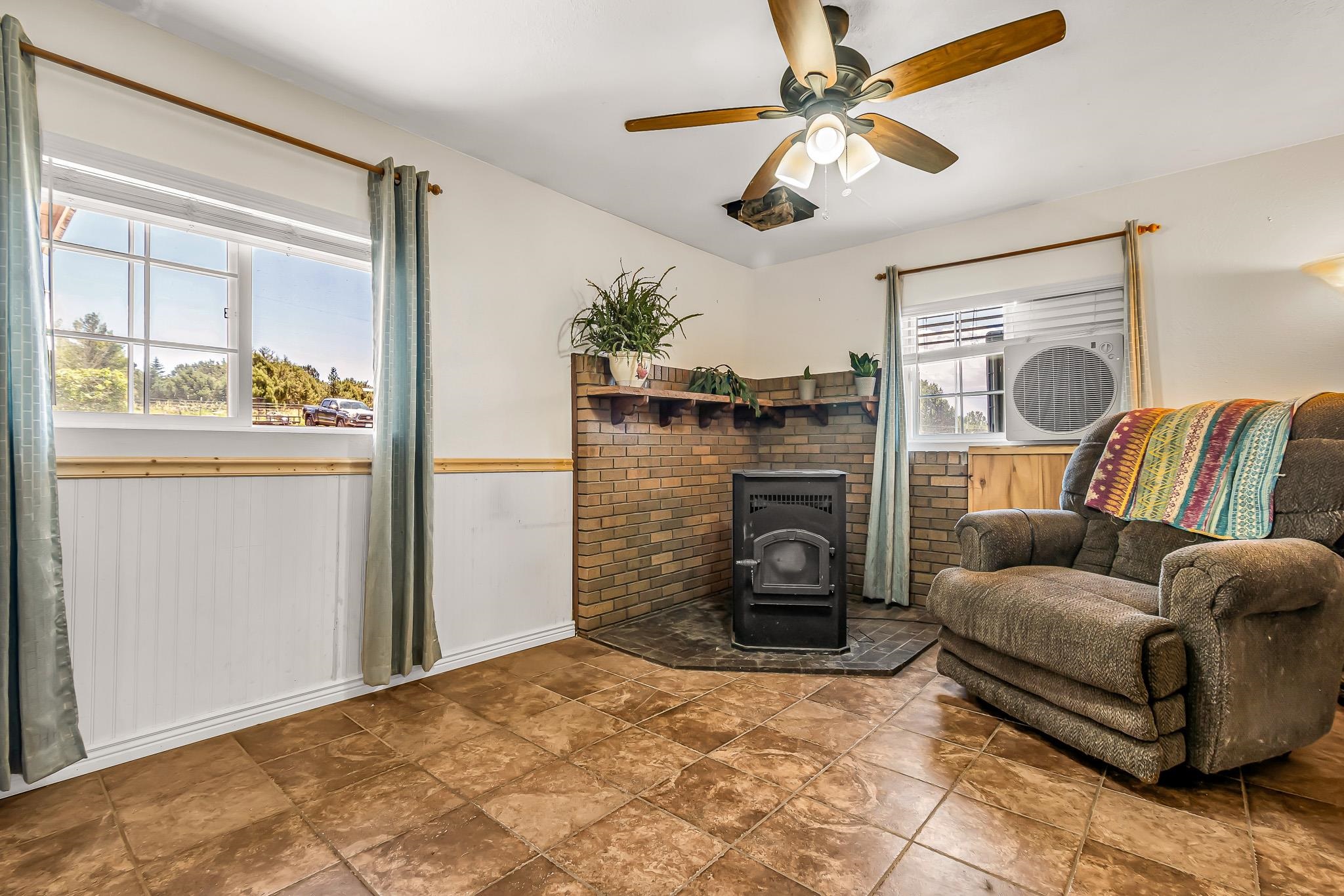 24413 Ute Trail Road Cedaredge, CO 81413 - Photo 5 of 40 a living room with furniture and a fireplace