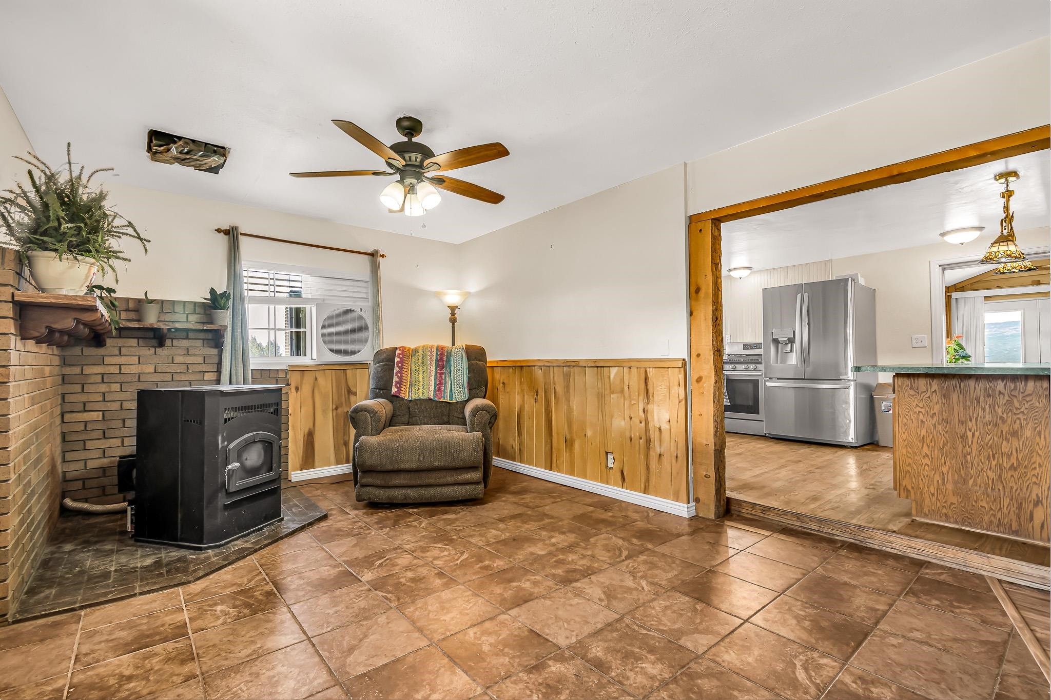 24413 Ute Trail Road Cedaredge, CO 81413 - Photo 6 of 40 a living room with furniture and a fireplace