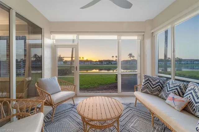 a living room with furniture and a floor to ceiling window