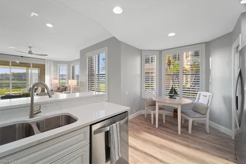 a kitchen with a sink and chairs