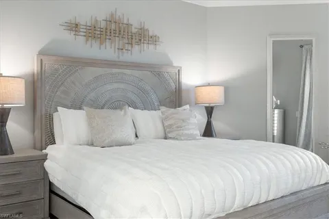 a bedroom with a bed and a night stand