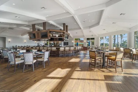 a view of a dining hall with lots of furniture and lots of chairs