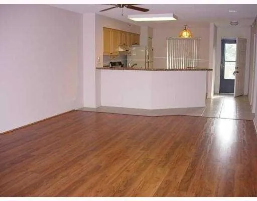 a view of a living room with wooden floor