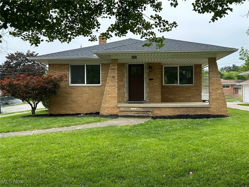 4281 Grannis Road Cleveland, OH 44126 - Photo 2 of 30 Bungalow-style house featuring brick siding, a chimney, a front lawn, and a shingled roof