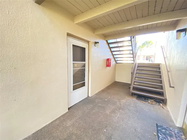 a view of a room with stairs and a window