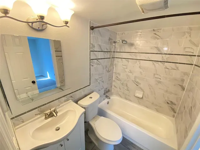 a bathroom with a sink a mirror and a toilet