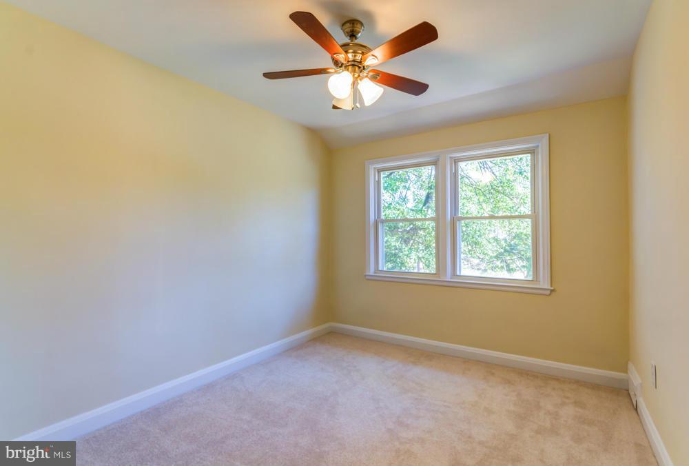 1027 Witherspoon Road Baltimore, MD 21212 - Photo 13 of 21 an empty room with a window and a fan