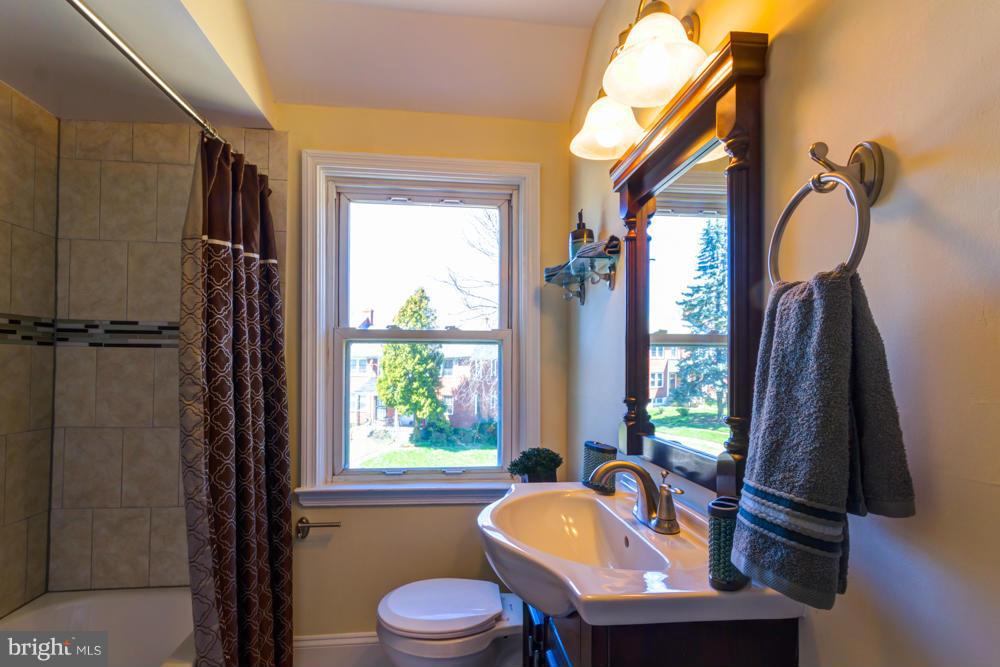 1027 Witherspoon Road Baltimore, MD 21212 - Photo 9 of 21 a bathroom with a sink a toilet and a mirror