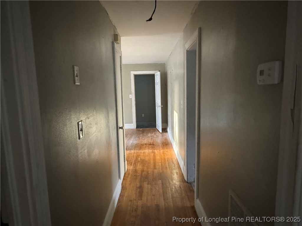 116 North Wright Street Raeford, NC 28376 - Photo 3 of 13 a view of a hallway with wooden floor