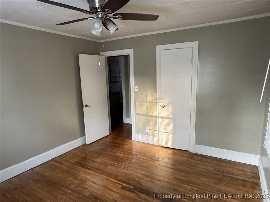 116 North Wright Street Raeford, NC 28376 - Photo 5 of 13 wooden floor in an empty room with a window