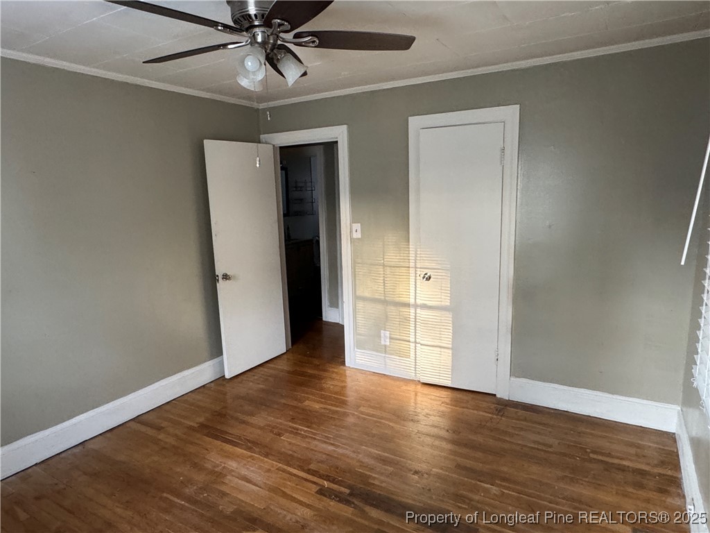 116 North Wright Street Raeford, NC 28376 - Photo 6 of 13 wooden floor in an empty room with a window