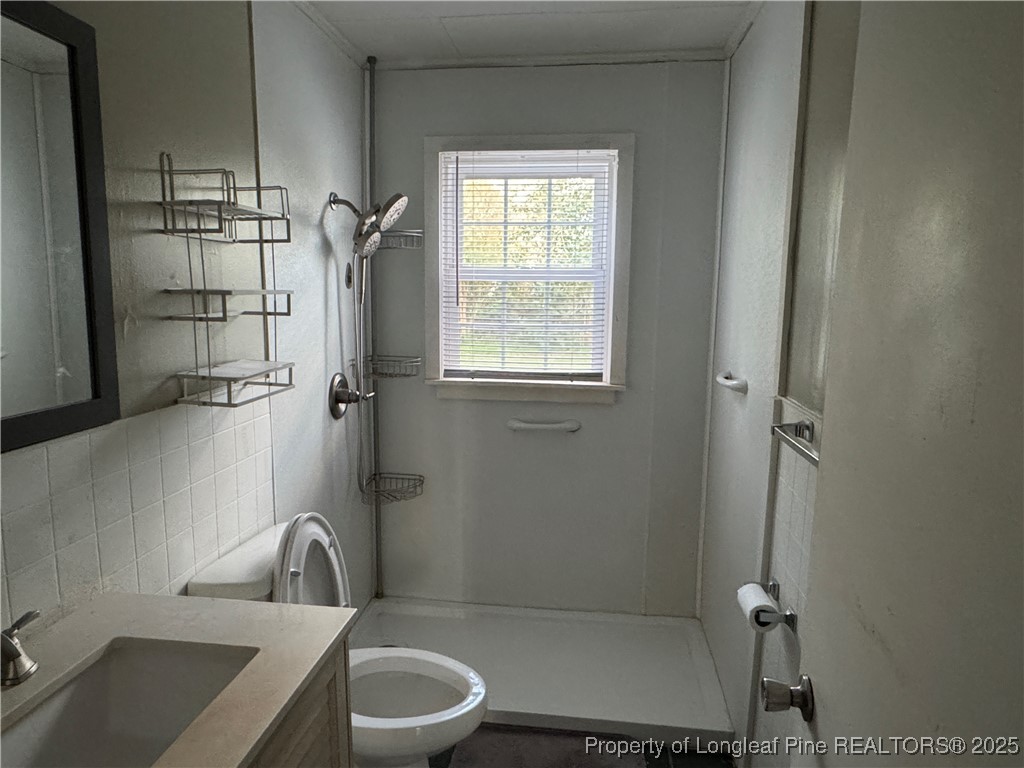116 North Wright Street Raeford, NC 28376 - Photo 8 of 13 a bathroom with a sink toilet and shower