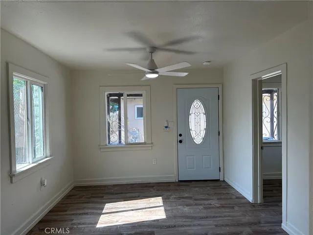 a kitchen with a sink cabinets and wooden floor