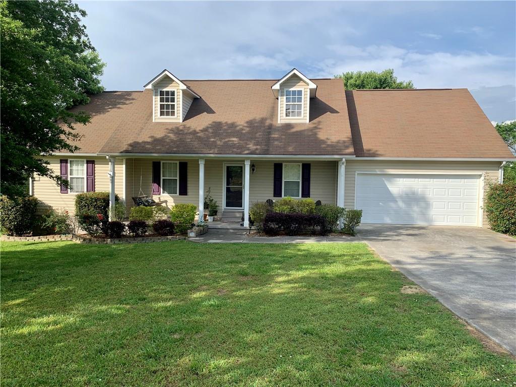 566 Owens Chapel Road Southeast Calhoun, GA 30701 - Photo 1 of 1 a front view of a house with a garden
