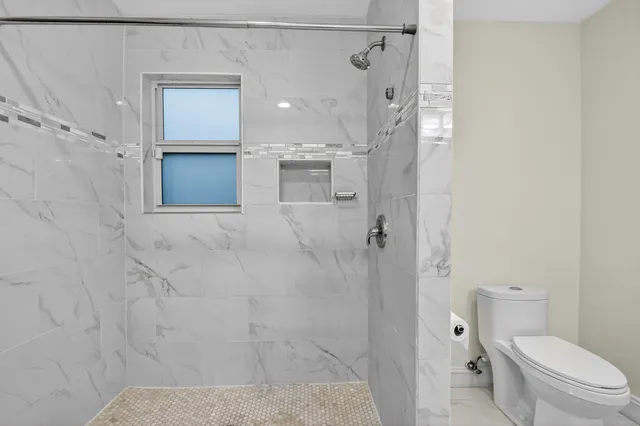 a bathroom with a shower toilet and sink