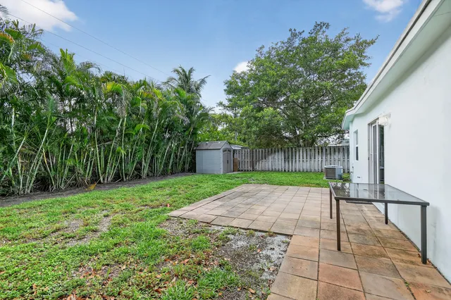 a view of backyard with patio