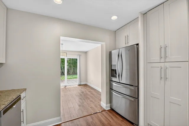 a metallic refrigerator freezer sitting in a kitchen