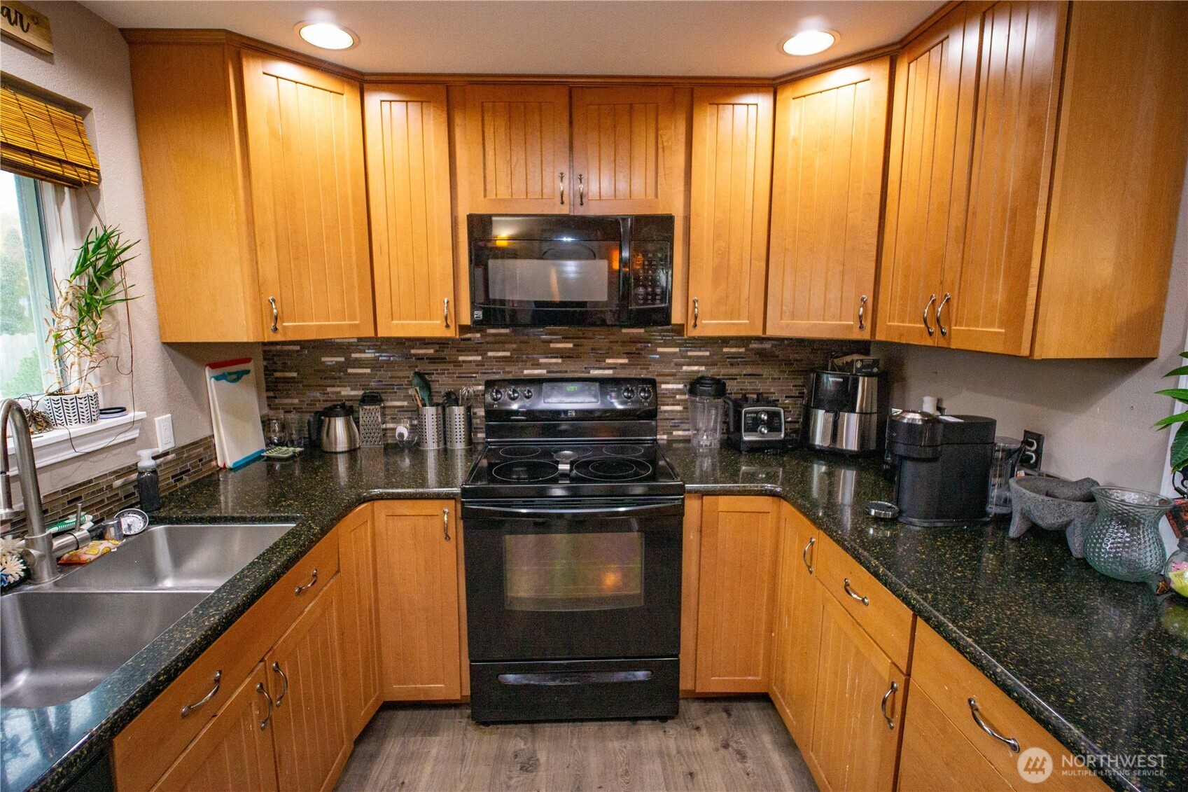 151 Valley View Drive Sequim, WA 98382 - Photo 12 of 40 a kitchen with kitchen island granite countertop a sink window and cabinets