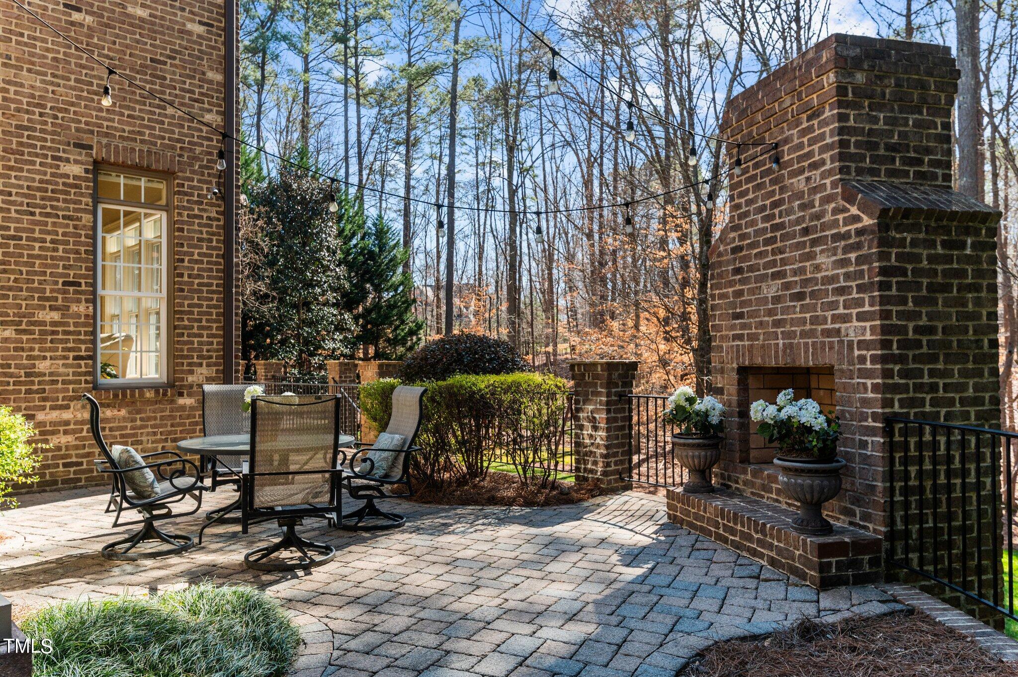 2108 Cadenza Lane Raleigh, NC 27614 - Photo 24 of 43 Off of the kitchen, step down to the patio and wood burning fireplace.