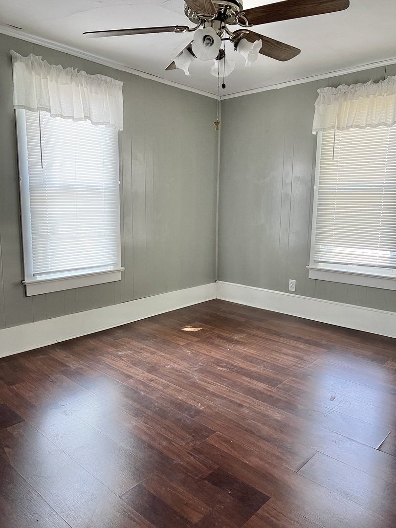 113 Wilson Avenue Chadwick, IL 61014 - Photo 11 of 19 an empty room with wooden floor and windows