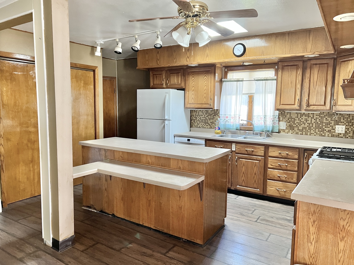 113 Wilson Avenue Chadwick, IL 61014 - Photo 3 of 19 a kitchen with stainless steel appliances granite countertop a refrigerator a sink dishwasher a stove and white countertops with wooden floor