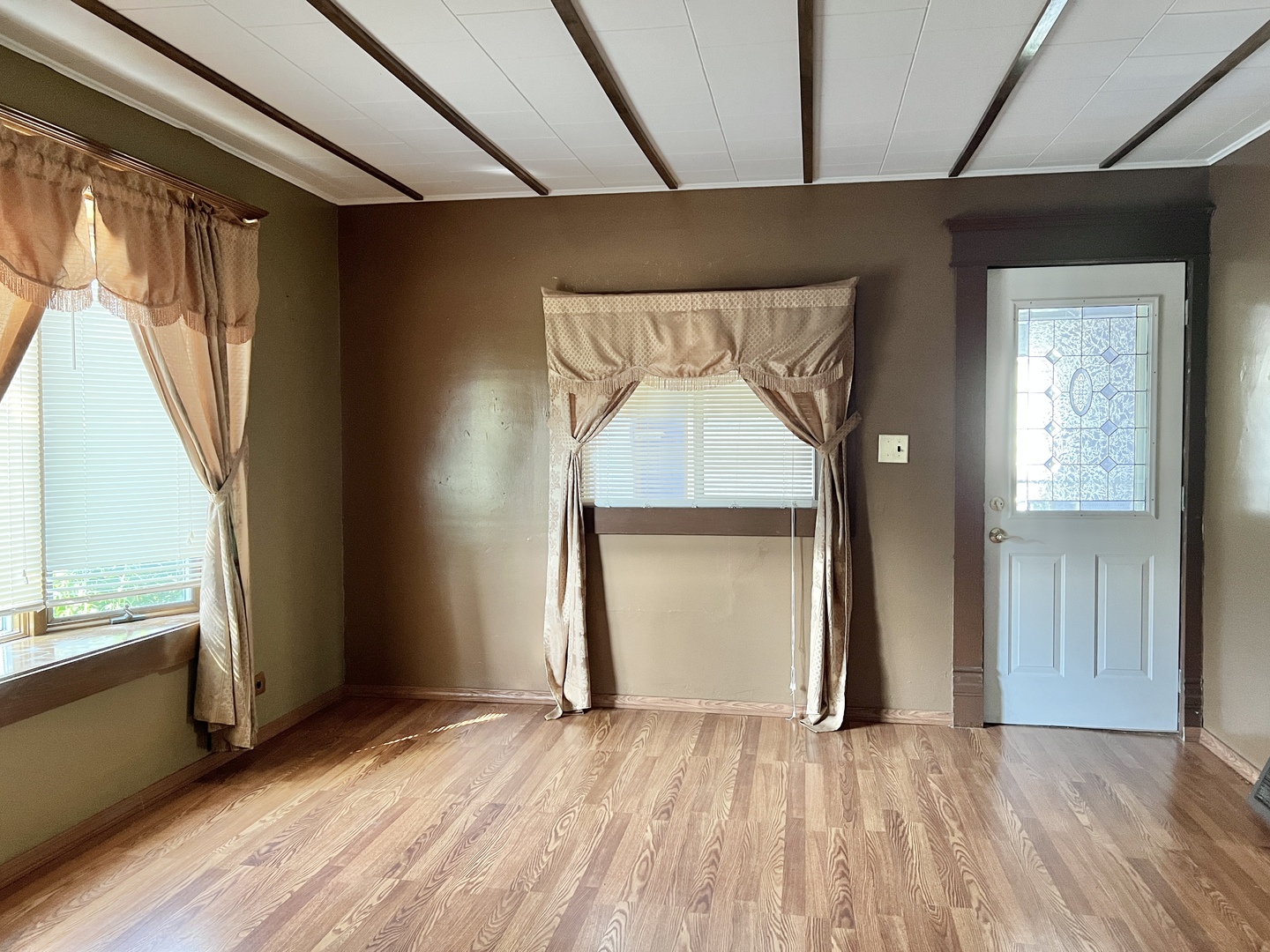 113 Wilson Avenue Chadwick, IL 61014 - Photo 7 of 19 a view of an empty room with wooden floor and a window