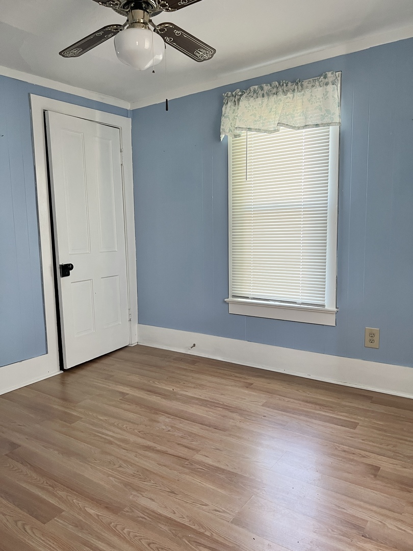 113 Wilson Avenue Chadwick, IL 61014 - Photo 10 of 19 a view of an empty room with wooden floor and a window
