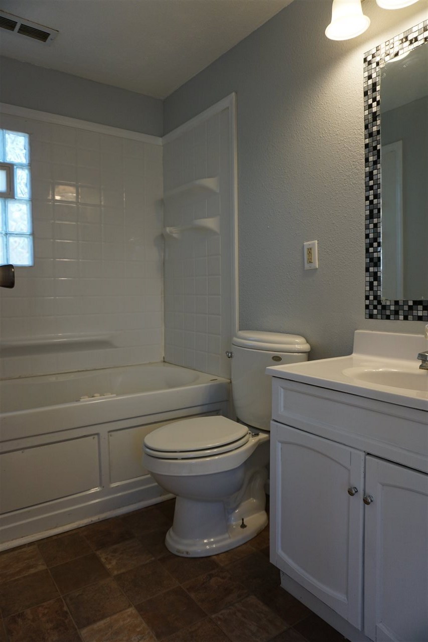 422 Fitch Road Rockford, IL 61109 - Photo 6 of 11 a bathroom with a sink a toilet and tub