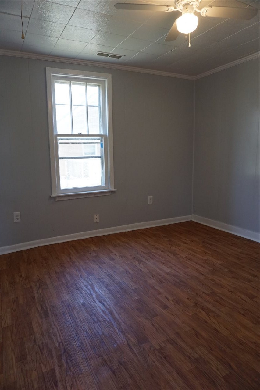 422 Fitch Road Rockford, IL 61109 - Photo 8 of 11 an empty room with wooden floor and windows