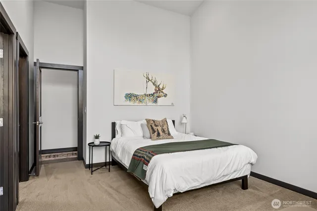 a bedroom with a bed and a painting on the wall