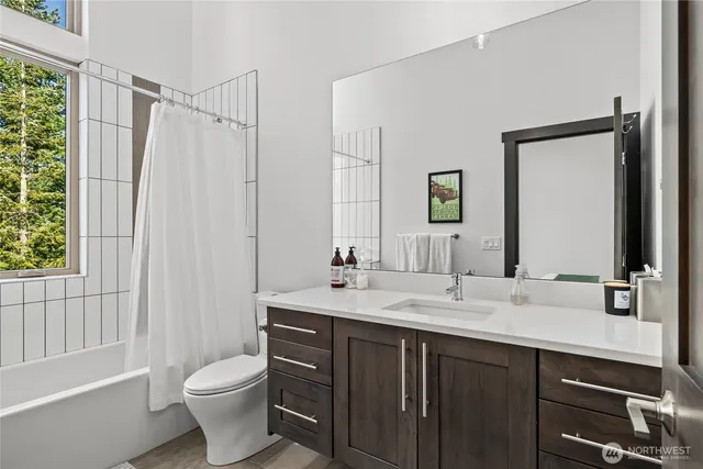 a bathroom with a double vanity sink toilet and shower